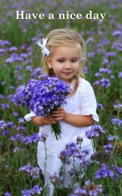 Little girl in a field with a bouquet of flowers